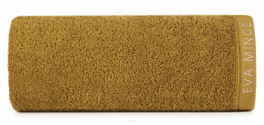 Ręcznik 50x90 VENUS Eva Minge miodowy zdobiony bordiurą w kolorze ręcznika z napisami projektantki 550 g/m2